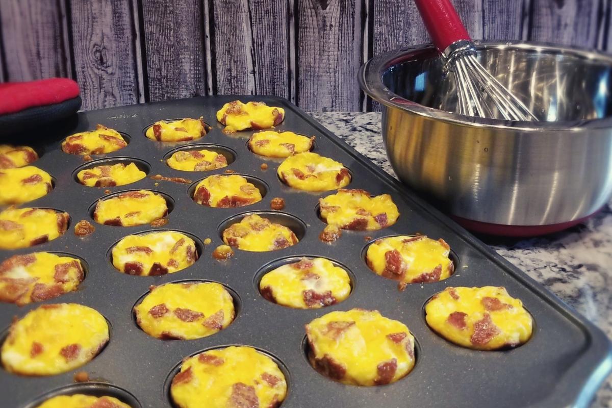 Mini egg bacon and cheese muffins in a pan.